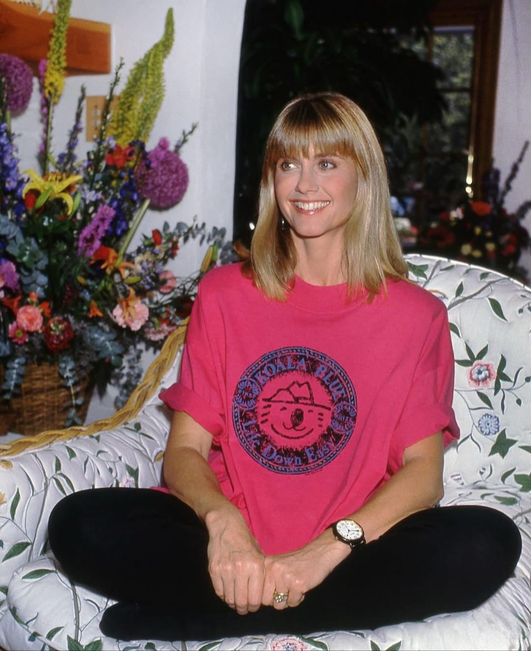 Olivia Newton-John Wearing Original Graphic T-Shirt with Koala Blue Life Down Easy Logo from her 1980’s Clothing Brand