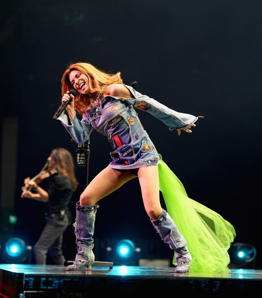 Live Photo of Shania Twain Performing Onstage Wearing Nikki and Kim Embroidered Patch Denim Dress