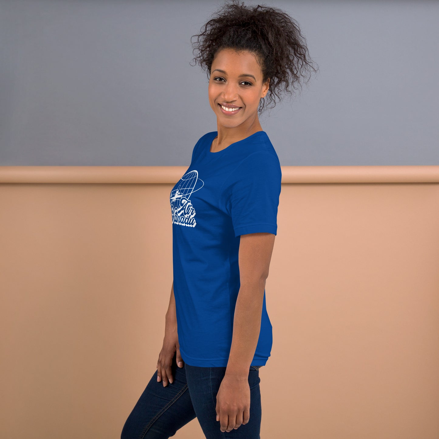 Woman Wearing Blue Graphic T-Shirt with Air Xanadu Logo Inspired by the Olivia Newton-John 80’s Roller Disco Movie