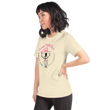 Side View of Woman Wearing Natural-Colored Graphic T-Shirt with Koala Blue Aussie Milk Bar Logo Inspired by Olivia Newton-John’s 1980’s Clothing Brand