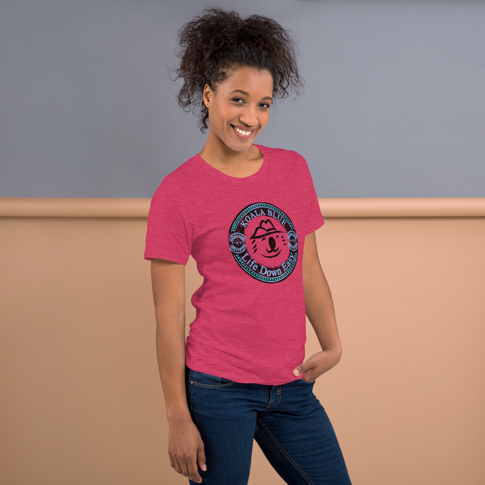 Front View of Woman Wearing Raspberry-Colored Graphic T-Shirt with Koala Blue Life Down Easy Logo Inspired by Olivia Newton-John's 1980's Clothing Brand